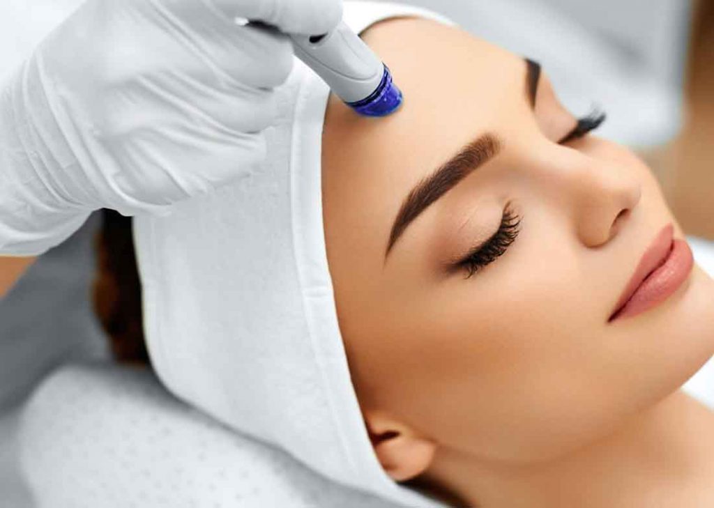 Woman receiving facial treatment